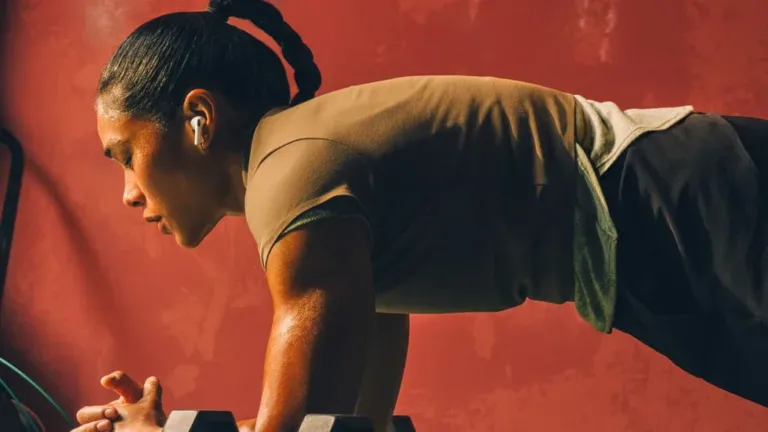Person wearing Apple AirPods Pro 3 during a strength-training workout