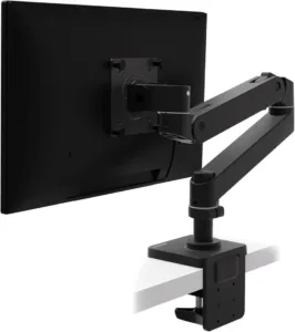 Black Ergotron LX Pro monitor arm clamped to a desk, shown from behind the monitor