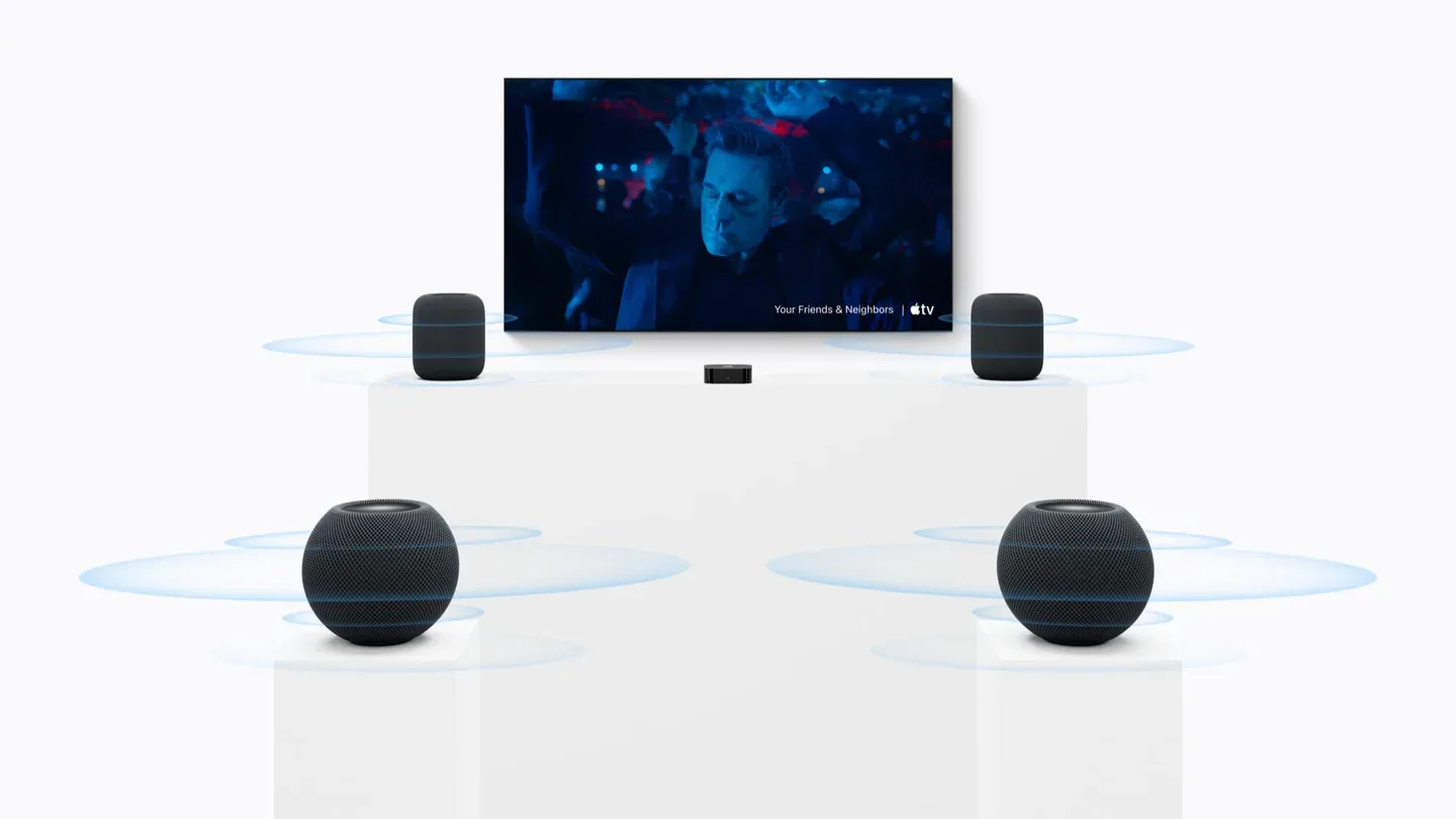 Two full-size HomePods at the front of a TV room and two HomePod mini 2 speakers at the rear